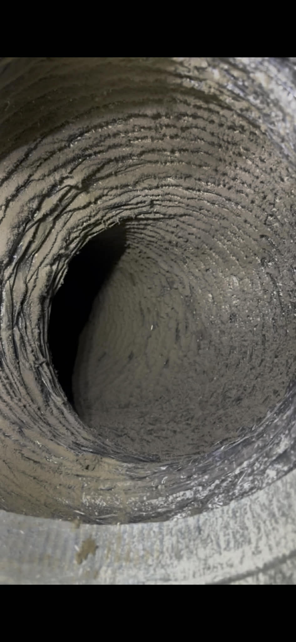 Dirty air duct with heavy dust buildup before professional cleaning in Memphis TN