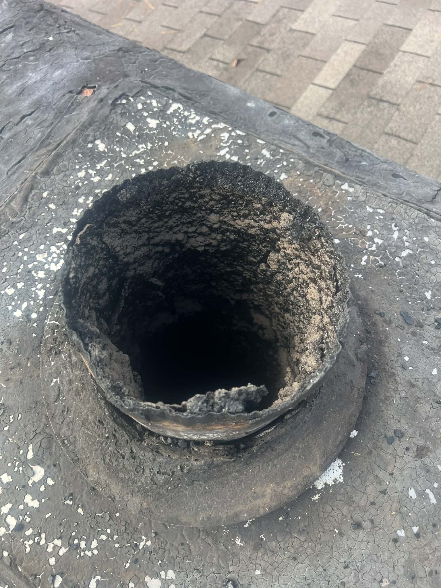 Professional chimney sweep cleaning the flue of a Memphis home